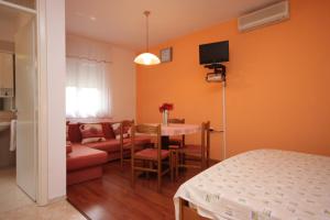 a room with a bed and a table and a couch at Apartments with a parking space Icici, Opatija - 7761 in Ičići