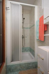 a bathroom with a shower and a bath tub at Apartments with a parking space Icici, Opatija - 7788 in Ičići