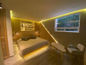 a bedroom with a bed and a window with lights at Carcamanes 17 Gastro-Hotel in Guanajuato