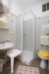 a bathroom with a shower and a toilet and a sink at Apartments with a parking space Icici, Opatija - 7763 in Ičići