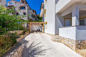 a walkway between two buildings at Apartments with a parking space Mali Losinj (Losinj) - 8026 in Mali Lošinj