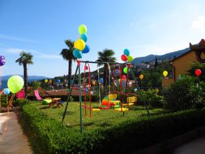 a park with a playground with balloons and a swing at Apartments with a parking space Icici, Opatija - 7793 in Ičići