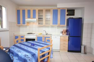 a kitchen with blue cabinets and a blue refrigerator at Holiday house with a parking space Brsec, Opatija - 7795 in Brseč +19 photos