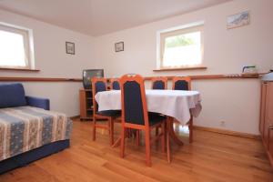 a dining room with a table and four chairs at Family friendly seaside apartments Moscenicka Draga, Opatija - 7798 in Mošćenička Draga +24 photos