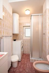 a bathroom with a shower and a toilet and a sink at Apartments with a parking space Icici, Opatija - 7822 in Ičići