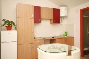 a kitchen with a glass table and a refrigerator at Apartments with a parking space Opatija - 7891 in Opatija +16 photos