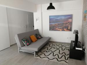 a living room with a couch and a rug at Paradise Space in Lisbon