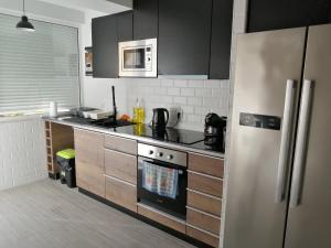 a kitchen with a refrigerator and a stove top oven at Paradise Space in Lisbon