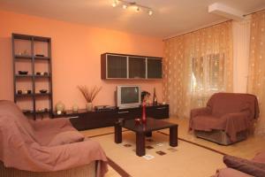 a living room with two chairs and a television at Apartments with a parking space Opatija - 7857 in Opatija