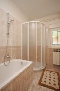a large bathroom with a tub and a shower at Apartments with a parking space Opatija - 7857 in Opatija