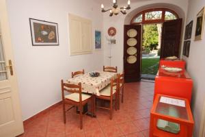 ein Esszimmer mit einem Tisch, Stühlen und einer Tür in der Unterkunft Apartments by the sea Opatija - Volosko, Opatija - 7911 in Opatija