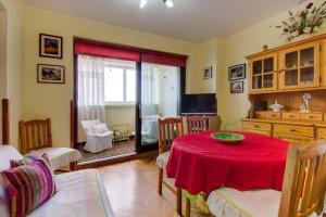 a living room with a table with a red table cloth at Apartments with a parking space Mali Losinj (Losinj) - 8000 in Mali Lošinj