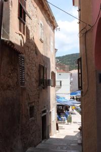 an alley in an old town with buildings at Apartments by the sea Cres - 7875 in Cres