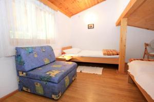 a small room with a bed and a chair in it at Apartments with a parking space Artatore, Losinj - 7938 in Čunski