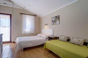 a bedroom with two beds in a room at Apartments by the sea Artatore, Losinj - 7934 in Čunski
