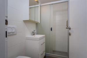 een witte badkamer met een toilet en een wastafel bij Apartments by the sea Artatore, Losinj - 7934 in Čunski +20 foto's