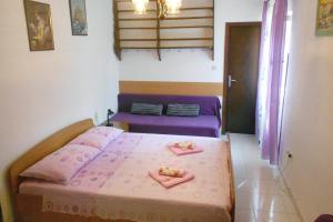 a bedroom with a bed with two plates of food on it at Apartments with a parking space Cres - 7984 in Cres