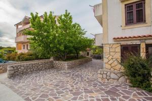 a stone walkway in front of a building at Apartments with a parking space Cres - 7983 in Cres