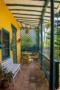 a patio with a table and chairs and awning at FINCA COCUYAL...todo un pesebre VIVO! in Rionegro