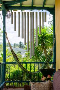 a hammock on a screened in porch with a view at FINCA COCUYAL...todo un pesebre VIVO! in Rionegro