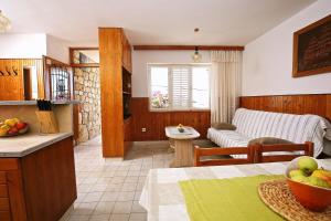 a kitchen and living room with a couch and a table at Apartments by the sea Prizba, Korcula - 9255 in Prizba