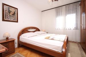 a bedroom with a bed with white sheets and a window at Rooms with WiFi Split - 9240 in Split