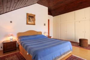 a bedroom with a blue bed and white cabinets at Seaside holiday house Brna, Korcula - 9235 in Smokvica