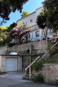 a large brick house with a garage at Apartments by the sea Medvinjak, Korcula - 9268 in Korčula