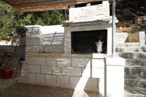 a fireplace being constructed in a yard at Secluded fisherman's cottage Cove Bratinja Luka, Korcula - 9224 in Korčula