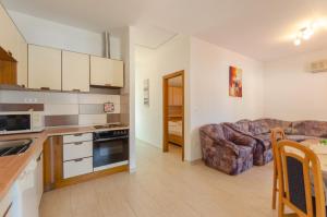 a kitchen and a living room with a couch at Apartment Brna 9162b in Smokvica