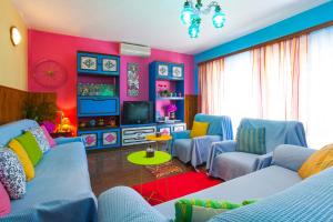 a colorful living room with blue couches and a tv at Apartments with parking space Brna, Korcula - 9188 in Smokvica