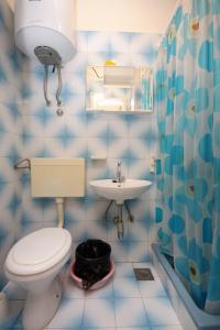 a blue and white bathroom with a toilet and sink at Apartments with parking space Brna, Korcula - 9188 in Smokvica +18 photos