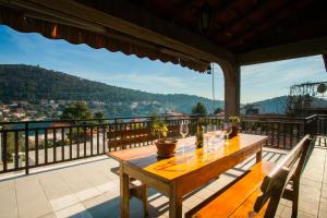 a wooden table on a balcony with a view at Apartments with parking space Brna, Korcula - 9188 in Smokvica
