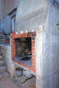 a brick oven with a pizza inside of it at Apartments by the sea Cove Stratincica, Korcula - 9264 in Vela Luka