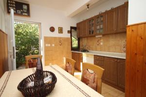 a kitchen with a table with a basket on it at Apartments by the sea Kneza, Korcula - 9164 in Pupnat