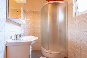 a bathroom with a shower and a sink at Apartments by the sea Kneza, Korcula - 9168 in Račišće +31 photos
