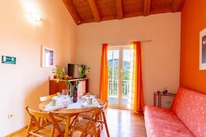 a living room with a table and a couch at Apartments by the sea Kneza, Korcula - 9168 in Račišće