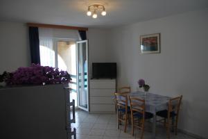 a kitchen and dining room with a table and chairs at Apartments by the sea Kneza, Korcula - 9166 in Pupnat