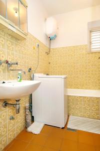 a bathroom with a sink and a toilet in it at Apartments and rooms by the sea Lumbarda, Korcula - 9272 in Lumbarda