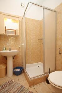 a bathroom with a shower and a sink at Apartments by the sea Kneza, Korcula - 9171 in Pupnat +38 photos