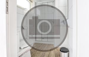 a bathroom with a shower with a round mirror at Lovely Ship In Aalsmeer With Harbor View in Aalsmeer