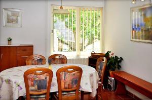 a dining room with a table with chairs and a window at Apartments by the sea Lumbarda, Korcula - 9173 in Lumbarda