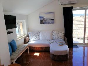 a living room with a couch and a table at Apartments by the sea Lumbarda, Korcula - 9173 in Lumbarda