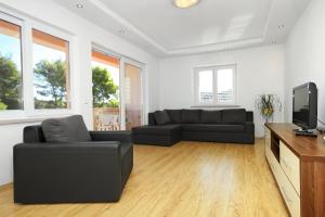 a living room with a couch and a tv at Apartments by the sea Lumbarda, Korcula - 9300 in Lumbarda