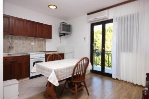 a kitchen with a table with a table cloth on it at Apartments by the sea Prigradica, Korcula - 9288 in Blato