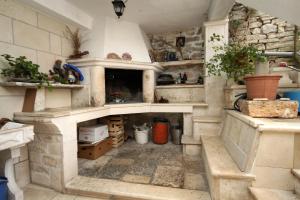 a kitchen with a stone fireplace in a room at Apartments by the sea Racisce, Korcula - 9169 in Račišće +15 photos