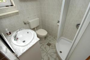 a bathroom with a sink and a toilet and a shower at Apartments with a parking space Racisce, Korcula - 9170 in Račišće