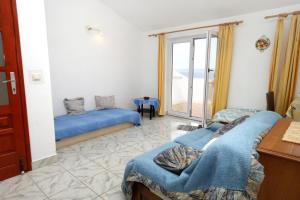 a room with two beds and a window at Apartments with a parking space Racisce, Korcula - 9170 in Račišće