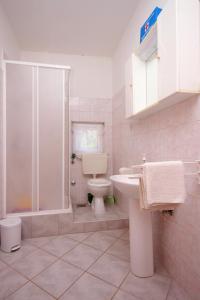a bathroom with a toilet and a shower and a sink at Seaside secluded apartments Grscica, Korcula - 9228 in Prizba