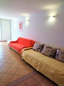 a room with two beds and a red couch at Apartments with a parking space Icici, Opatija - 7860 in Ičići